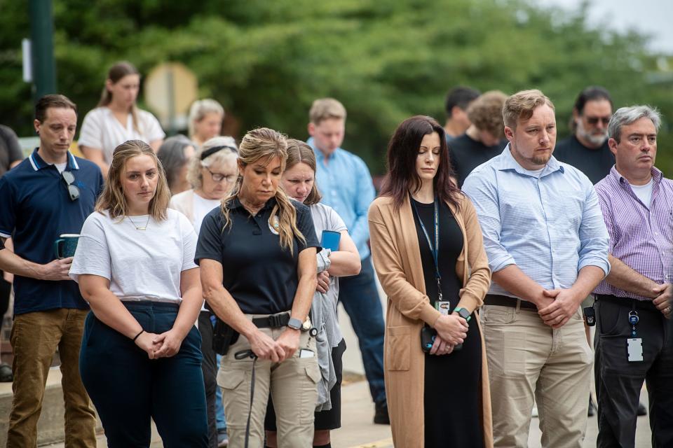 People bow their heads during a prayer at the conclusion of a 9/11 remembrance ceremony, September 11, 2023.