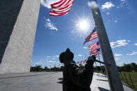 Phillip Bradley, with the National Park Service, lowers American flags around the Washington Monument to half-staff in honor of Colin Powell, former Joint Chiefs chairman and secretary of state. Powell has died from COVID-19 complications. In an announcement on social media Monday, the family said Powell had been fully vaccinated. He had also been treated over the past few years for multiple myeloma, a blood cancer. He was 84. (AP Photo/Alex Brandon)