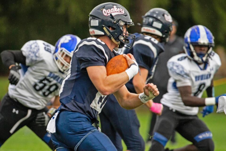 Wilmington Friends senior Andrew McKenzie (20) picks up yards against Howard during the game at the Wilmington Friends football field in Alapocas, Saturday, Oct. 7, 2023. Howard won 50-21.