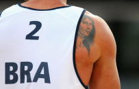 LONDON, ENGLAND - JULY 30: The tattoo of Pedro Cunha of Brazil is seen during the Men's Beach Volleyball Preliminary match between Brazil and Great Britain on Day 3 of the London 2012 Olympic Games at Horse Guards Parade on July 30, 2012 in London, England. (Photo by Ryan Pierse/Getty Images)