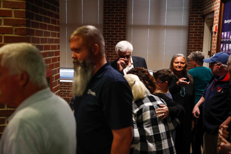 Members of the McCraw family gather together and talk after a meeting regarding road expansion that would destroy part of their farm at the Historic Montgomery County Courthouse in Clarksville, Tenn., on Monday, April 4, 2022. 