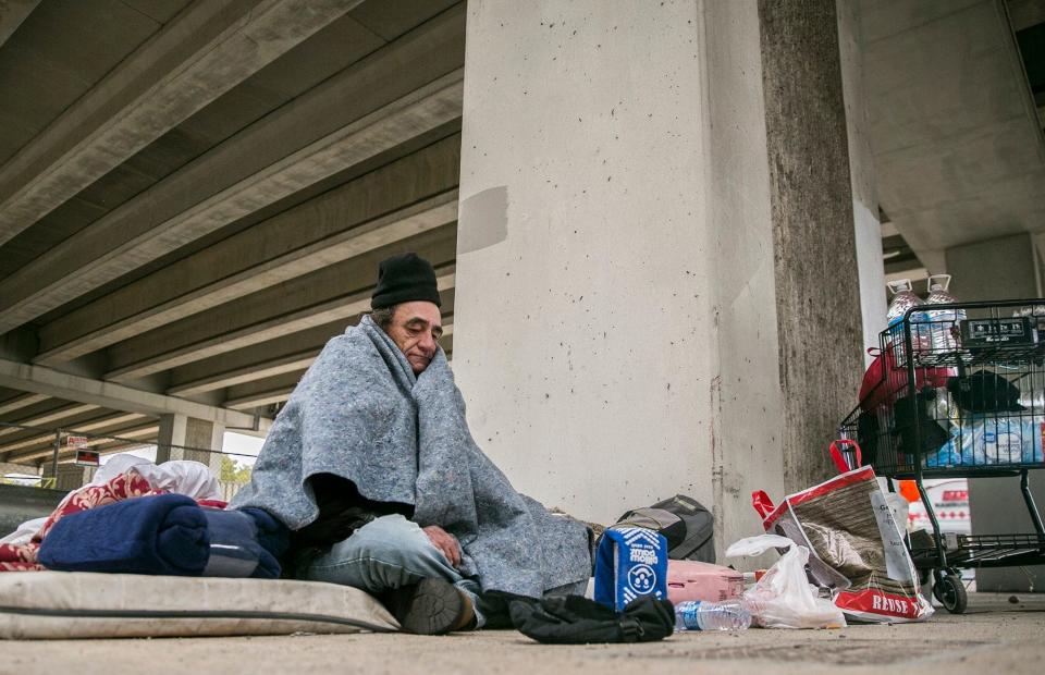 Jerry Ogg, also known on the street as "Chief," sits under an overpass at Texas 71 and Menchaca Road. He says he tries to stay warm with blankets at night. Homeless shelters such as the ARCH in downtown Austin will close their doors once they reach capacity.