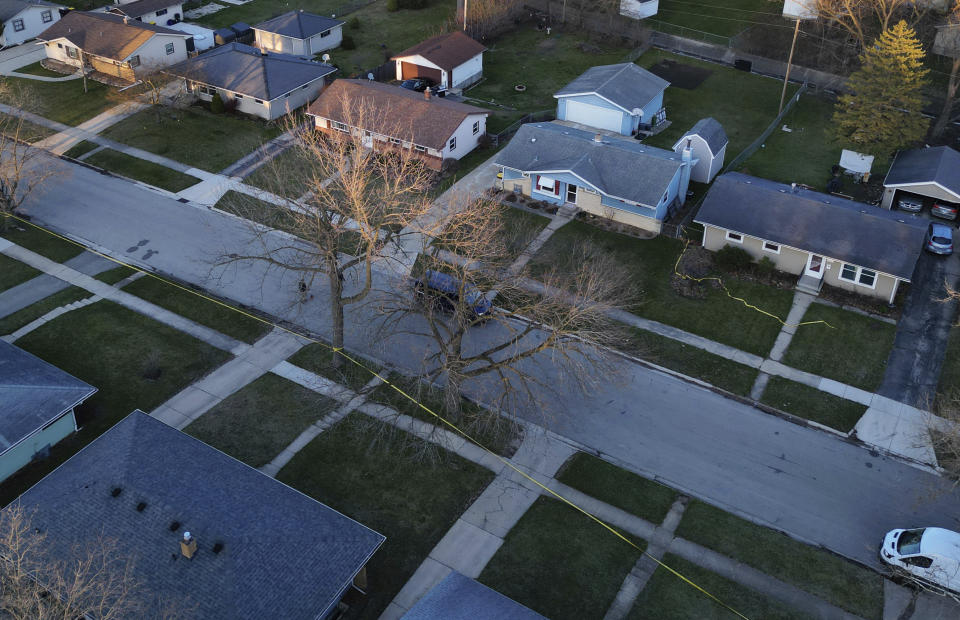 Police tape surrounds many homes as police investigate a mass stabbing along the 2300 block of Holmes Street on March 27, 2024, in Rockford, Ill. (Stacey Wescott/Chicago Tribune via AP)