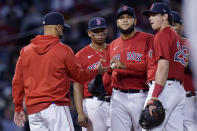 Boston Red Sox starting pitcher Eduardo Rodriguez hands the ball to manager Alex Cora as he is taken out in the fifth inning of the team's baseball game against the Houston Astros at Fenway Park, Thursday, June 10, 2021, in Boston. (AP Photo/Elise Amendola)