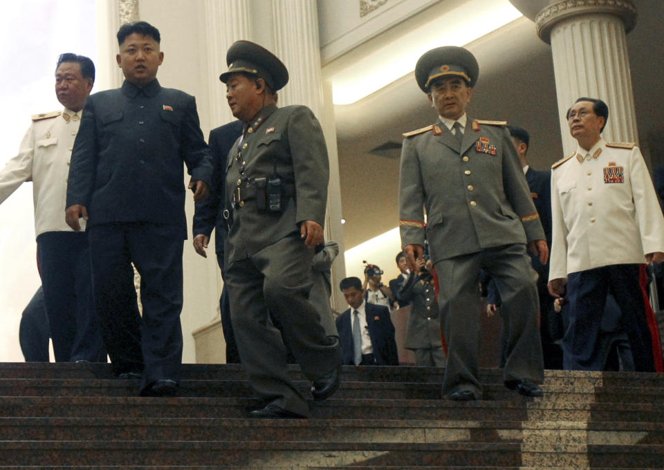 FILE - In this July 27, 2013 file photo, North Korean leader Kim Jong Un, second left, tours the newly-opened Fatherland Liberation War Museum, with his uncle Jang Song Thaek, right, Yang Hyong Sop, second right, vice president of the Presidium of North Korea's parliament, and Vice Marshal Choe Ryong Hae, left, as part of celebrations for the 60th anniversary of the Korean War armistice in Pyongyang, North Korea. Since taking power in late 2011, Kim Jong Un has executed or purged a slew of high-level government officials in what the South Korean government has described as a "reign of terror." The most spectacular was the 2013 execution by anti-aircraft fire of his uncle, Jang, once considered the country's second-most-powerful man, for what the North alleged was treason.(AP Photo/Wong Maye-E, File)