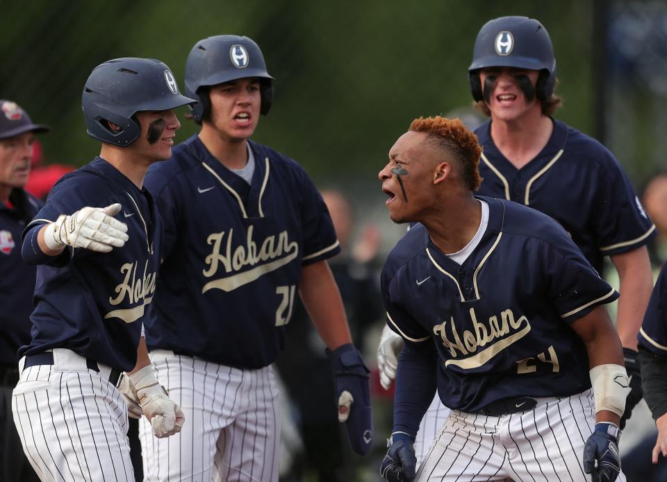 Archbishop Hoban second baseman Shawn Parnell (24) celebrates after his inside the park home run against Bay Village during the fifth inning of a Division II district semifinal baseball game in North Ridgeville on Monday, May 23, 2022.