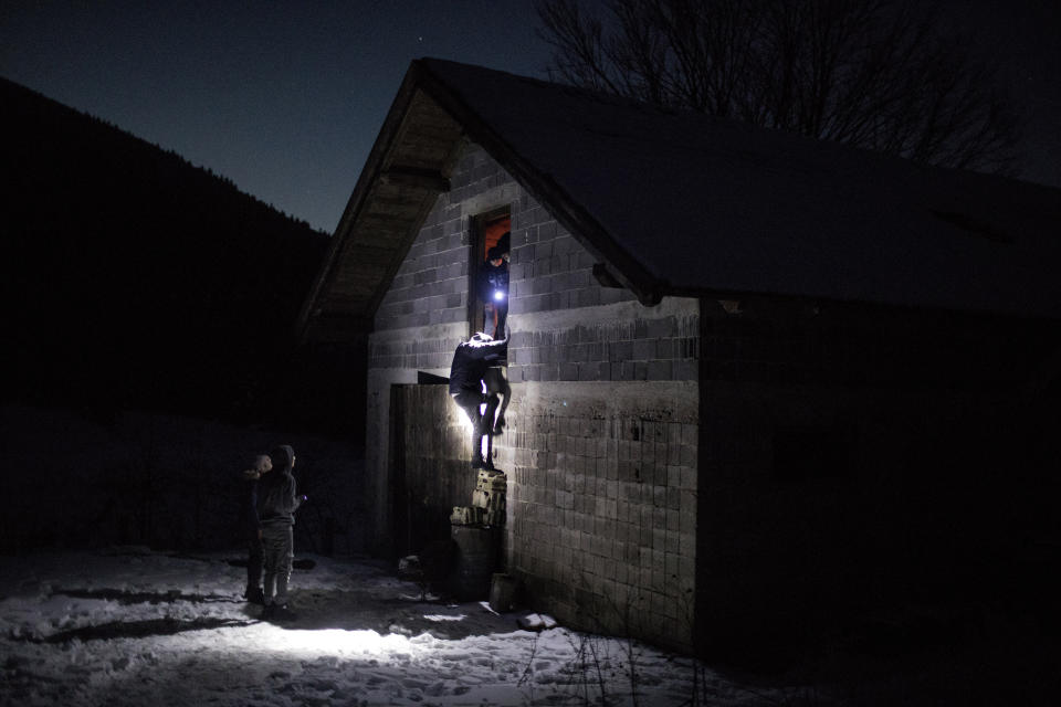 A group of Afghan migrants enter an abandoned farm near the border with Croatia to use it as shelter before attempting to cross the border into the EU near Bihac, northeast Bosnia on Dec. 14, 2019. (Photo: Manu Brabo/AP)  