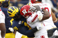 Michigan defensive lineman Kwity Paye (19) stops Rutgers running back Raheem Blackshear (2) in the first half of an NCAA college football game in Ann Arbor, Mich., Saturday, Sept. 28, 2019. (AP Photo/Paul Sancya)