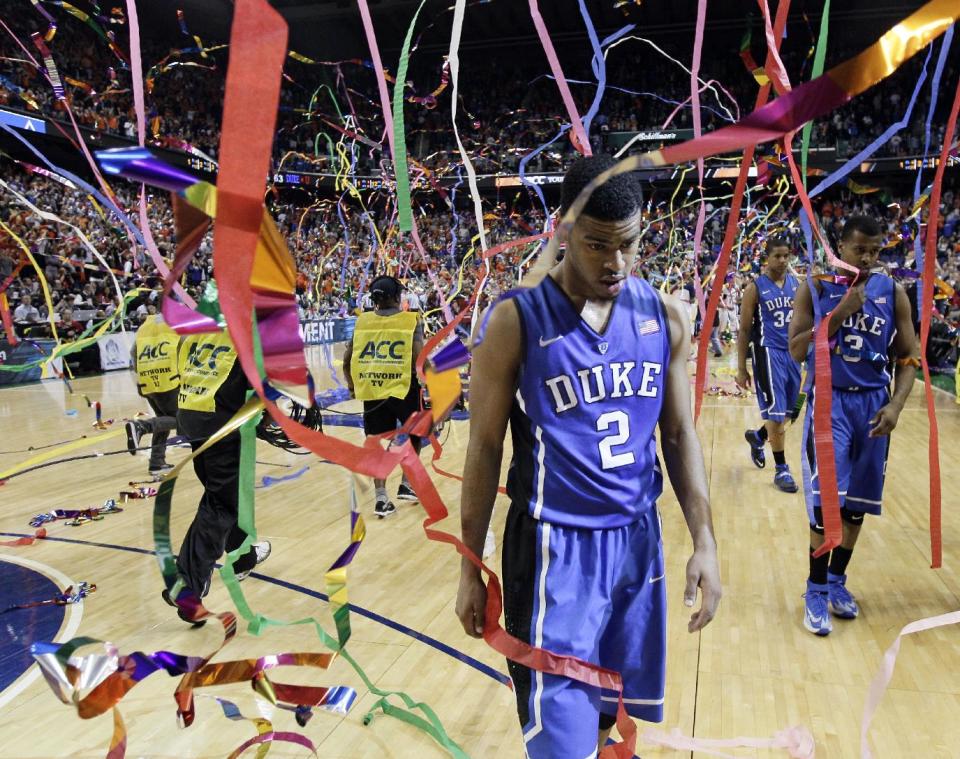 Duke's Quinn Cook (2) walks off the court after losing to Virginia in an NCAA college basketball game in the championship for the Atlantic Coast Conference tournament in Greensboro, N.C., Sunday, March 16, 2014. Virginia won 72-63. (AP Photo/Gerry Broome)