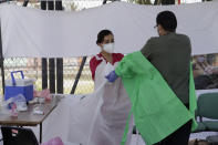 Medical personnel carry out disinfection protocol and equipment removal after carrying out tests for possible detection of possible COVID-19 in Lomas de San Lorenzo, Iztpalapa, on July 15, 2020, one of the neighborhoods in Mexico City that returned to a lockdown due to the high number of infections by coronavirus in the capital. (Photo by Gerardo Vieyra/NurPhoto via Getty Images)
