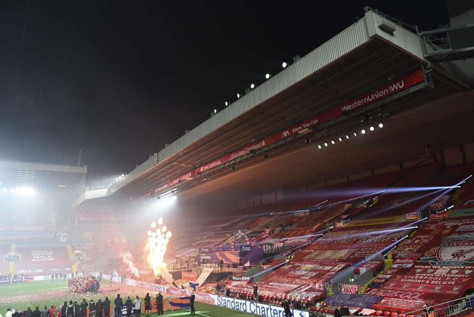 Liverpool players celebrate with the English Premier League trophy following the English Premier League soccer match between Liverpool and Chelsea at Anfield Stadium in Liverpool, England, Wednesday, July 22, 2020. Liverpool are champions of the EPL for the season 2019-2020. The trophy is presented at the teams last home game of the season. Liverpool won the match against Chelsea 5-3. (Laurence Griffiths, Pool via AP)