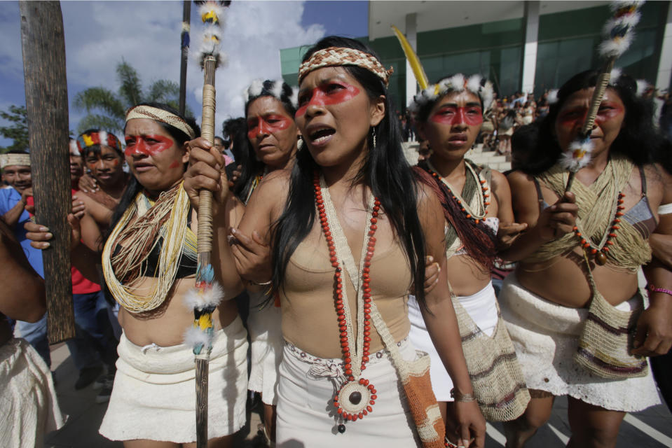 Waoranis and leader Nemonte Nenquimo leave a courthouse after a judged ruled in their favor in a lawsuit filed against the Ministry of Non-Renewable Natural Resources for opening up oil concessions on their ancestral land, in Puyo, Ecuador, Friday, April 26, 2019. The Amazon tribe has won an early court victory in its fight to stop oil extraction in its ancestral territory. A judge in a provincial court determined Friday that the Waorani people have a right to be consulted before any oil drilling takes place. (AP Photo/Dolores Ochoa)