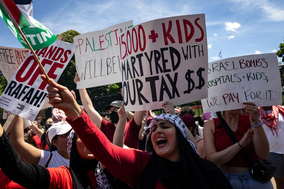 Pro-Palestinian activists hold up signs and chant on Pennsylvania Avenue in front of the White House during a demonstration protesting the war in Gaza on Saturday in Washington, D.C.  (Samuel Corum / Getty Images)