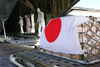 In this photo provided by Japan Joint Staff Office, a Japan Air Self-Defense Force aircraft arrives at Tonga's Fua'amotu International Airport, near Nuku'alofa, Saturday, Jan. 22, 2022 to deliver aid after an undersea volcano eruption. (Japan Joint Staff Office via AP)