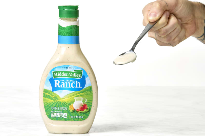 shot of hidden valley brand ranch in the bottle and on the spoon.
