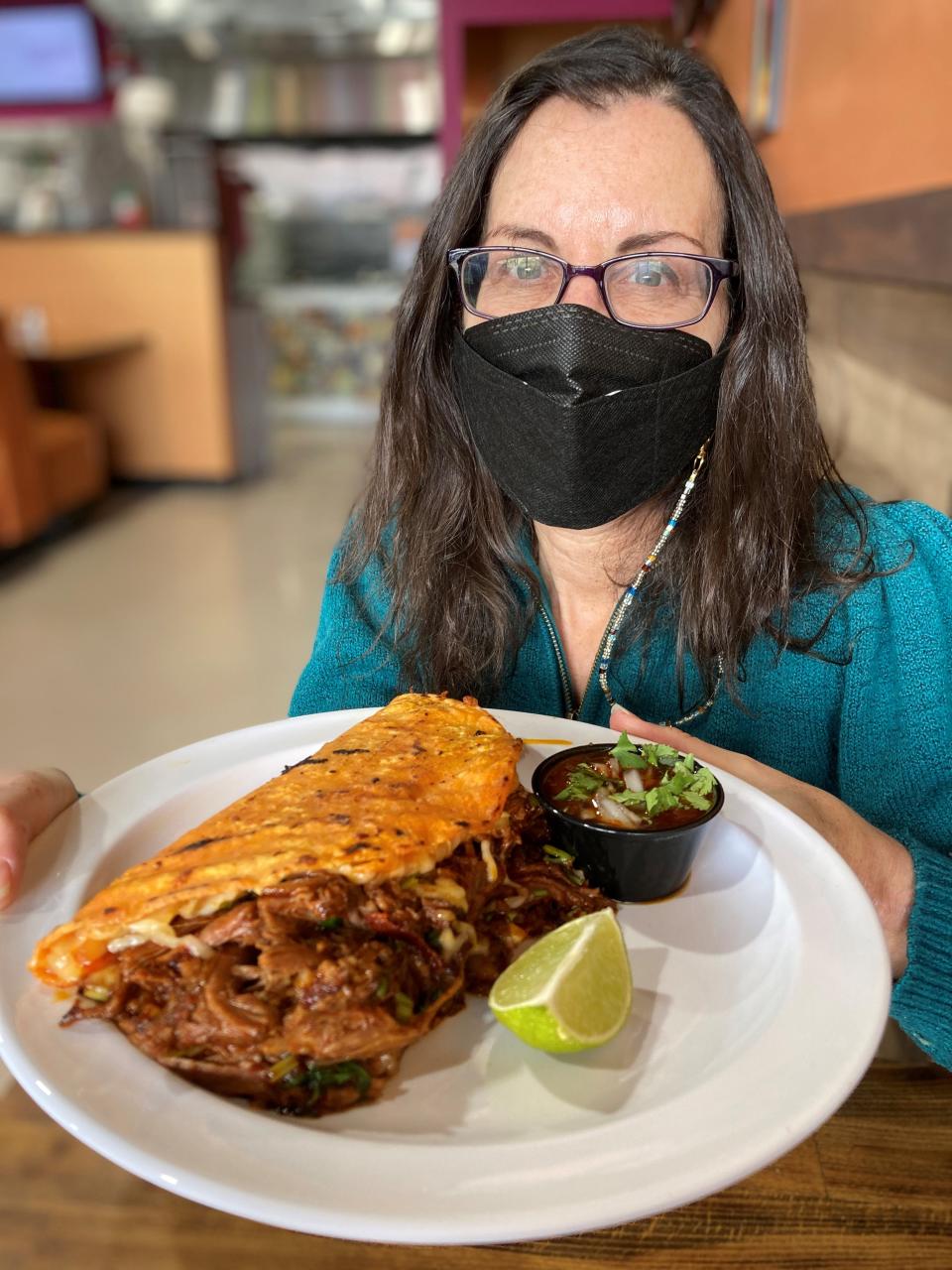 Lohud Food & Dining Reporter Jeanne Muchnick with the quesabirria at La Hacienda Meat and Grocery Market in Yonkers. Photographed Jan. 26, 2022.