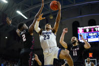 Villanova's Jermaine Samuels (23) goes up for a shot between Pennsylvania's Jonah Charles (2) and Michael Moshkovitz (11) during the first half of an NCAA college basketball game, Wednesday, Dec. 1, 2021, in Philadelphia. (AP Photo/Matt Slocum)