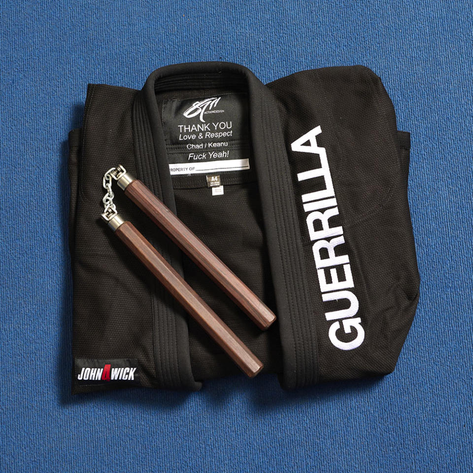 Reeves presents stunt staff with customized gi accompanied by the actor’s training nunchucks.