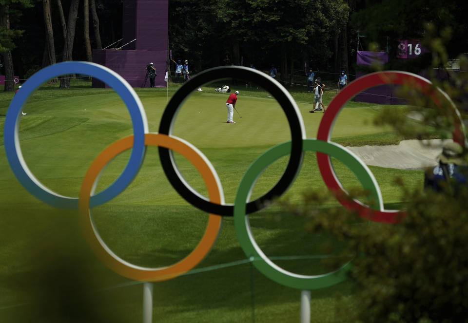 Austria's Sepp Straka, center, makes a putt on the 16th hole during the first round of the men's golf event at the 2020 Summer Olympics on Wednesday, July 28, 2021, at the Kasumigaseki Country Club in Kawagoe, Japan. (AP Photo/Matt York)