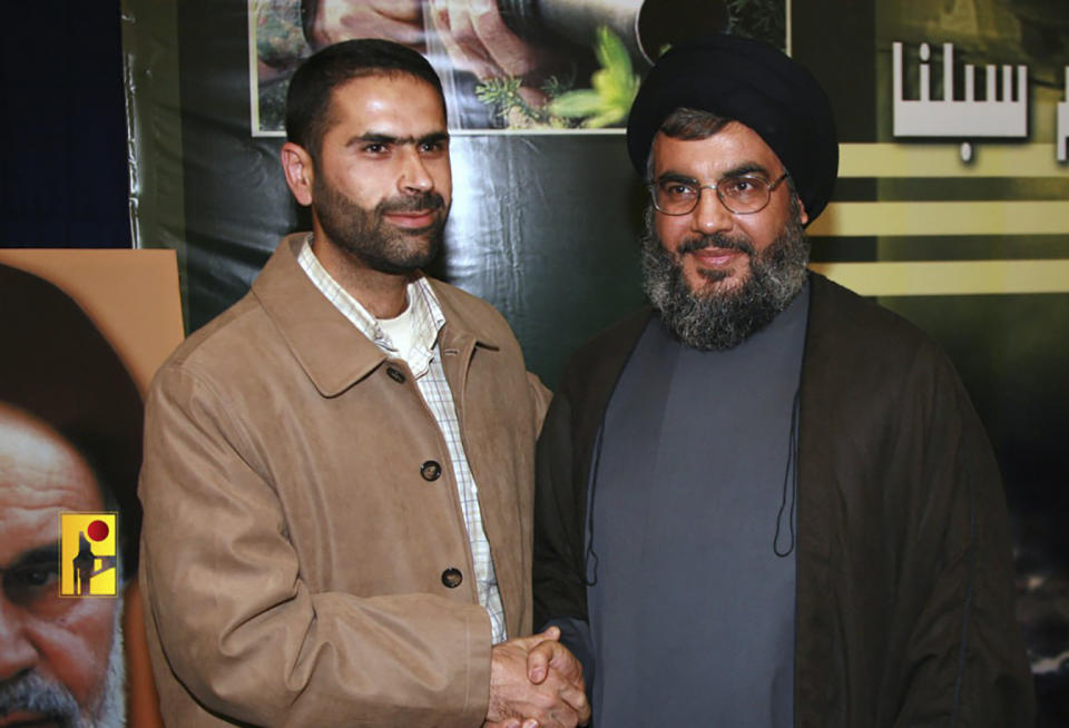 This undated picture released by Hezbollah Military Media, shows senior Hezbollah commander Wissam Tawil, left, who was killed in Kherbet Selem village, south Lebanon, on Monday, Jan. 8, 2024, shaking hands with Hezbollah leader Sayed Hassan Nasrallah. An Israeli airstrike killed Tawil, who is an elite Hezbollah commander in southern Lebanon, the latest in an escalating exchange of strikes along the border that have raised fears of another Mideast war even as the fighting in Gaza exacts a mounting toll on civilians.(Hezbollah Military Media, via AP)