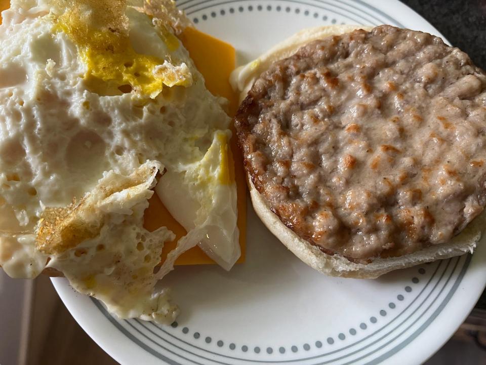 open-faced breakfast sandwich with sausage, egg, and cheese