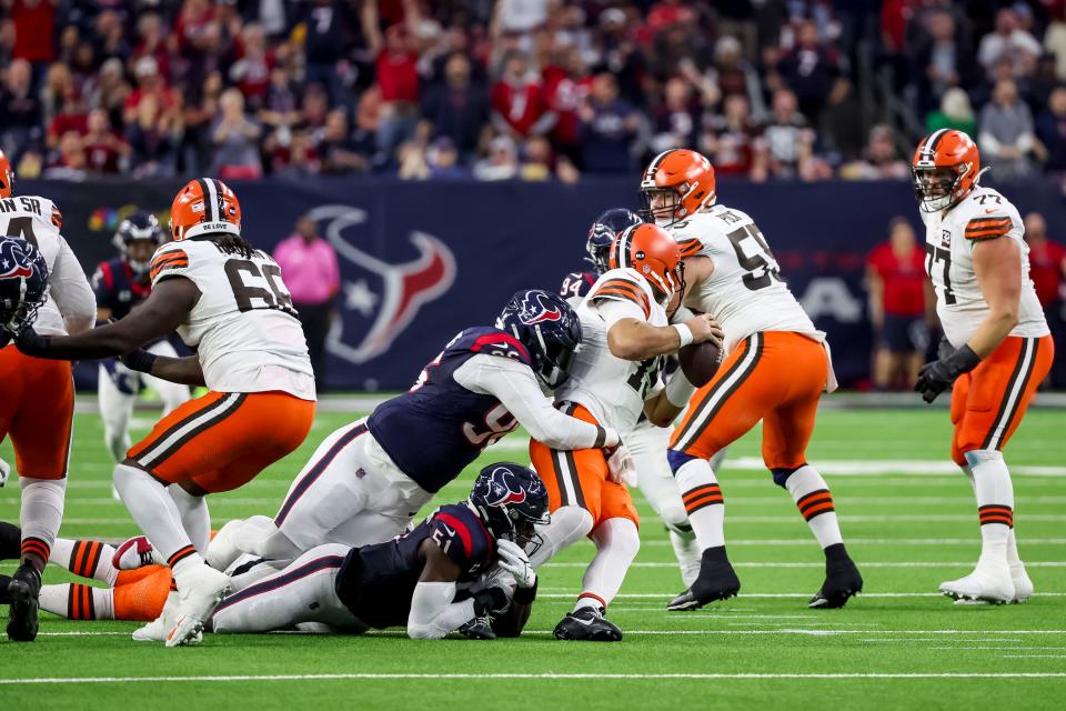 Cleveland Browns quarterback Joe Flacco (15) is sacked by Houston Texans defensive tackle Maliek Collins (96) and defensive end Will Anderson Jr. (51) during the second quarter Saturday in Houston.