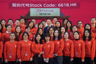 Xin Lijun, CEO of JD Health, stands amongst workers from the company for a photo during a ceremony to mark their stock listing on the Hong Kong stock exchange at the JD Headquarters in Beijing on Tuesday, Dec. 8, 2020. Shares in China's biggest online health care platform rose 40% in their Hong Kong stock market debut Tuesday, reflecting investor enthusiasm for the fledgling industry as the country emerges from the coronavirus pandemic. (AP Photo/Ng Han Guan)