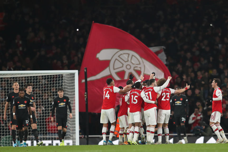 LONDON, ENGLAND - JANUARY 01: Sokratis Papastathopoulos of Arsenal celebrates with teammates after scoring a goal to make it 2-0 during the Premier League match between Arsenal FC and Manchester United at Emirates Stadium on January 1, 2020 in London, United Kingdom. (Photo by James Williamson - AMA/Getty Images)