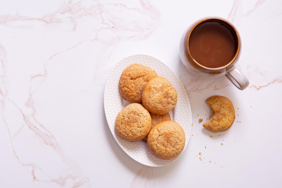 cookies on top of a plate next to hot chocolate