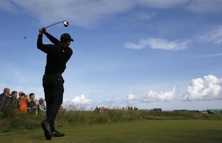 Tiger Woods of the U.S. watches his tee shot on the 12th hole during a practice round ahead of the British Open Championship at the Royal Liverpool Golf Club in Hoylake, northern England July 15, 2014. REUTERS/Stefan Wermuth