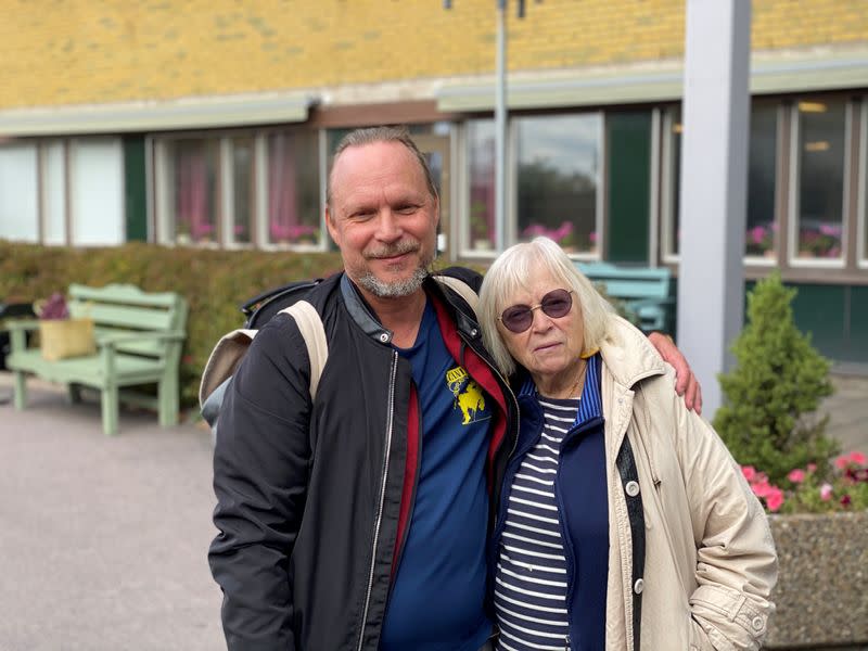 Ingrid Bolander, on her way to visit husband admitted to the care facility, poses with her son Pelle Bolander, in Gothenburg