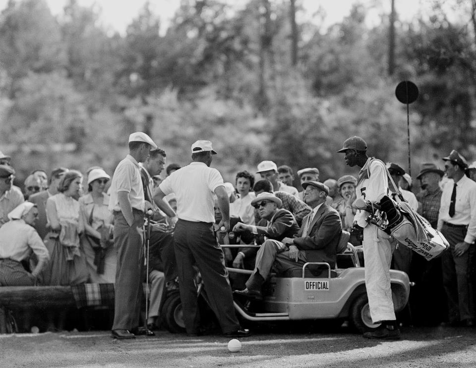 Arnold Palmer, center standing, argues a rules point at the 12th hole during the final round of the Masters at Augusta National Golf Club on April 6, 1958.