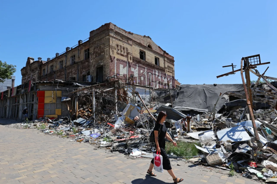 A woman walks by a destroyed building in Russian-occupied Mariupol <span class="copyright">REUTERS/Alexander Ermochenko</span>