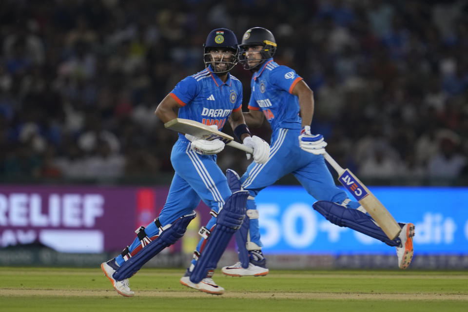 India's Ruturaj Gaikwad, left, and his batting partner Shubman Gill run between the wickets to score during the first one day international match between Australia and India in Mohali, India, Friday, Sept. 22, 2023. (AP Photo/Altaf Qadri)