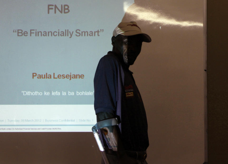 In this March 6, 2012 photo, a resident arrives at a banking workshop in the Zandspruit township, north of Johannesburg. Not so long ago banks wouldn't have been concerned about providing services for poor people. Now banks across Africa are seeing opportunity in the slums. (AP Photo/Denis Farrell)