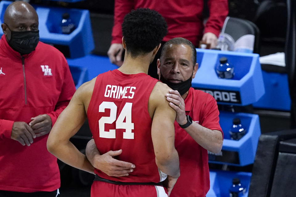 Houston guard Quentin Grimes (24) gets a hug from head coach Kelvin Sampson at the end of a men's Final Four NCAA college basketball tournament semifinal game against Baylor, Saturday, April 3, 2021, at Lucas Oil Stadium in Indianapolis. (AP Photo/Darron Cummings)