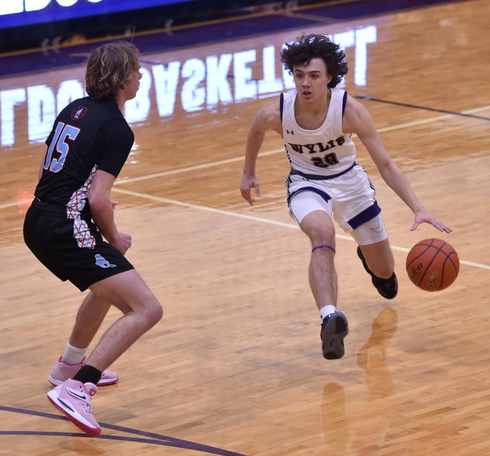 Abilene Wylie's Isaiah Carrillo, right, brings the ball up court as Lubbock Monterey's Carter Bovkoon defends in the first half. The Bulldogs beat Monterey 60-41 in a District 4-5A game Tuesday, Jan. 2, 2024, at Bulldog Gym.