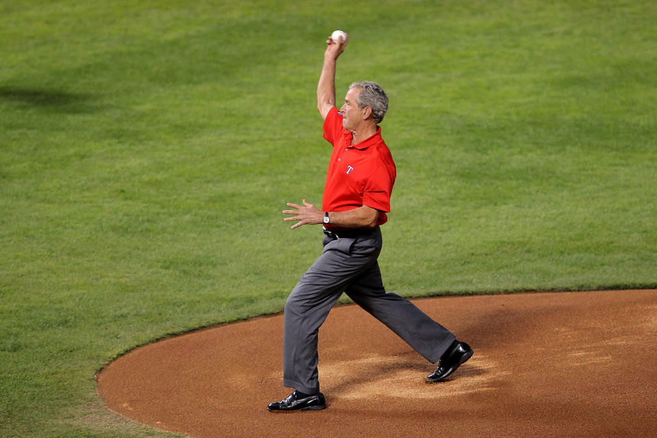 ARLINGTON, TX - OCTOBER 23: Former president George W. Bush throws out the ceremonial first pitch prior to Game Four of the MLB World Series between the St. Louis Cardinals and the Texas Rangers at Rangers Ballpark in Arlington on October 23, 2011 in Arlington, Texas. (Photo by Doug Pensinger/Getty Images)