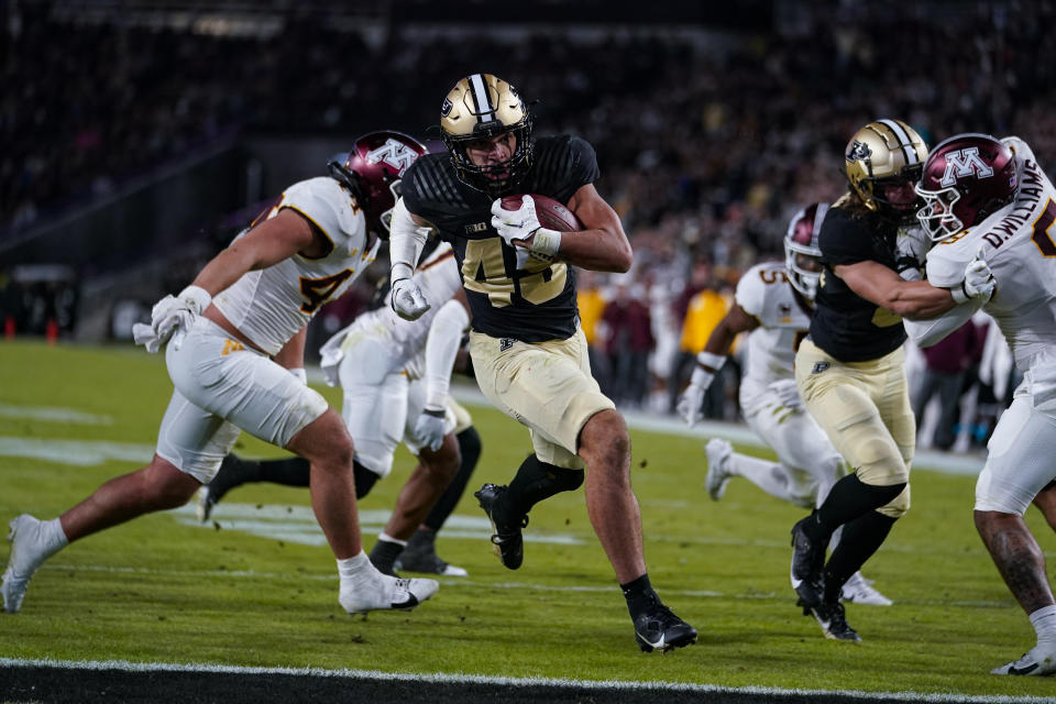 Purdue running back Devin Mockobee (45) runs in for a touchdown against Minnesota during the second half of an NCAA college football game in West Lafayette, Ind., Saturday, Nov. 11, 2023. (AP Photo/Michael Conroy)