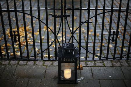 A candle burns for Madeleine McCann in Rothley, central England October 6, 2014. REUTERS/Darren Staples