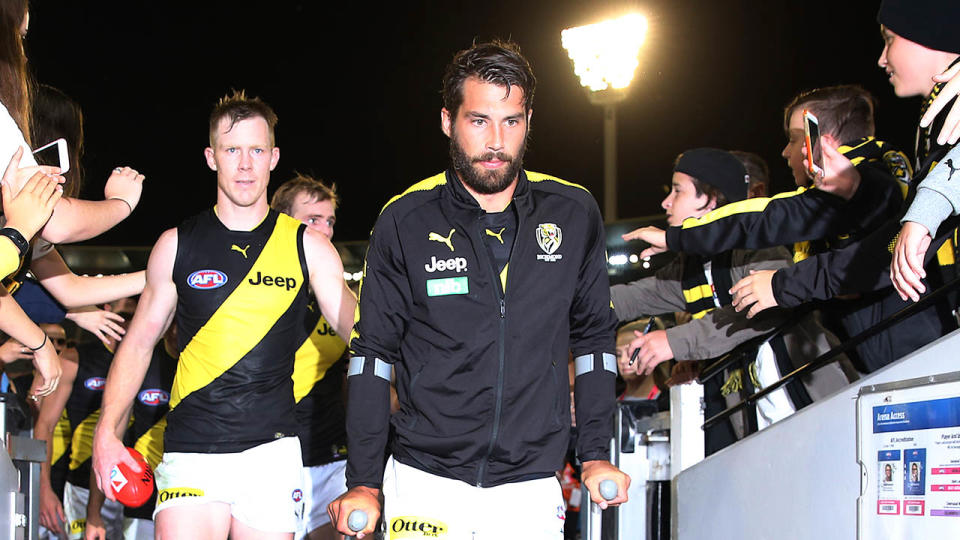 Jack Riewoldt (pictured left) helps Alex Rance (pictured right) down the tunnel. (Getty Images)