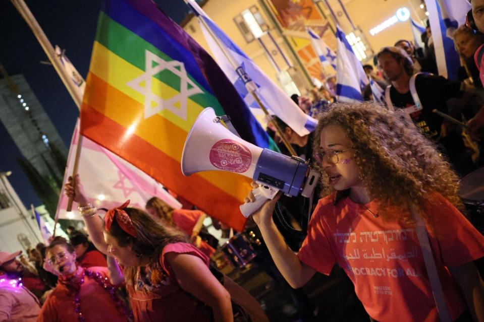 Demonstrators chant during a rally in Tel Aviv to protest the Israeli government's judicial overhaul bill, as the country begins celebrations for its 75th anniversary, on April 25, 2023. (Photo by JACK GUEZ / AFP) (Photo by JACK GUEZ/AFP via Getty Images)