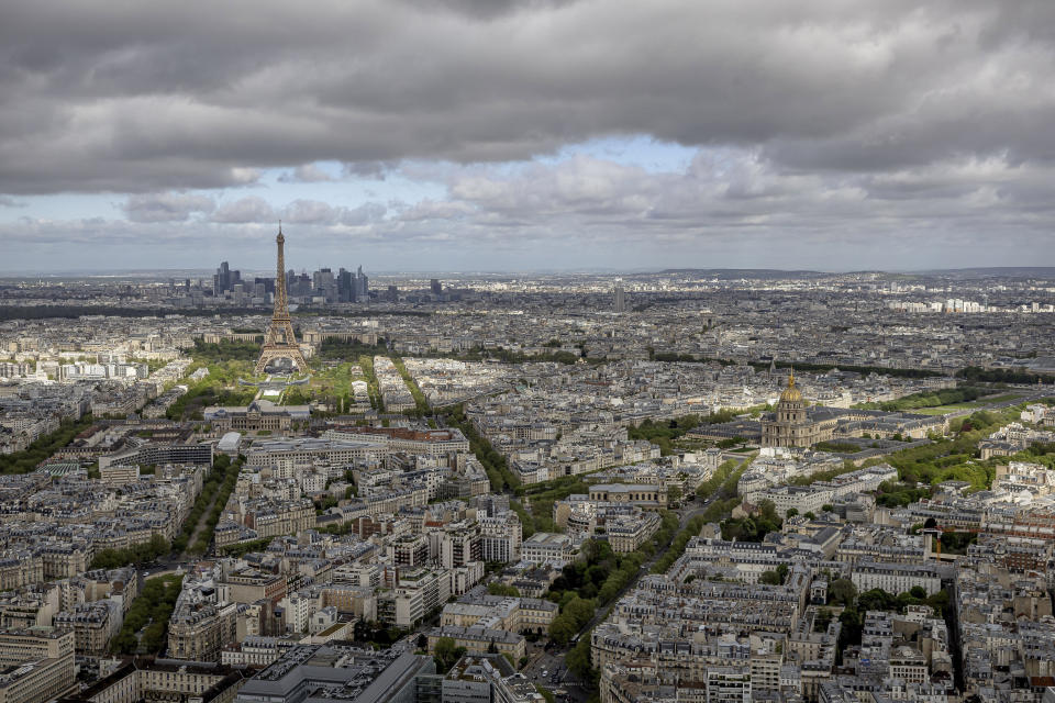 The Eiffel Tower and the Champs-de-Mars at its feet, the Invalides monument and its dome, right, are seen Monday, April 15, 2024 in Paris. The Champ-de-Mars will host the Beach Volleyball and Blind Football and the Invalides will host the Cycling road, Archery and Athetics events at the Paris 2024 Olympic and Paralympic Games. (AP Photo/Aurelien Morissard)