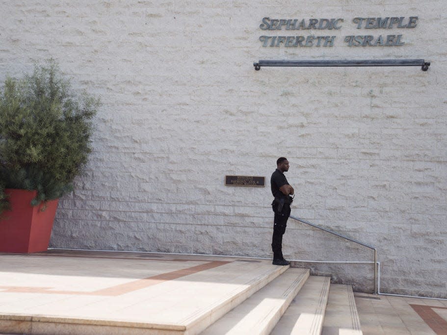 A security guard stands watch in front of a synagogue on October 9, 2023 in Los Angeles, California.