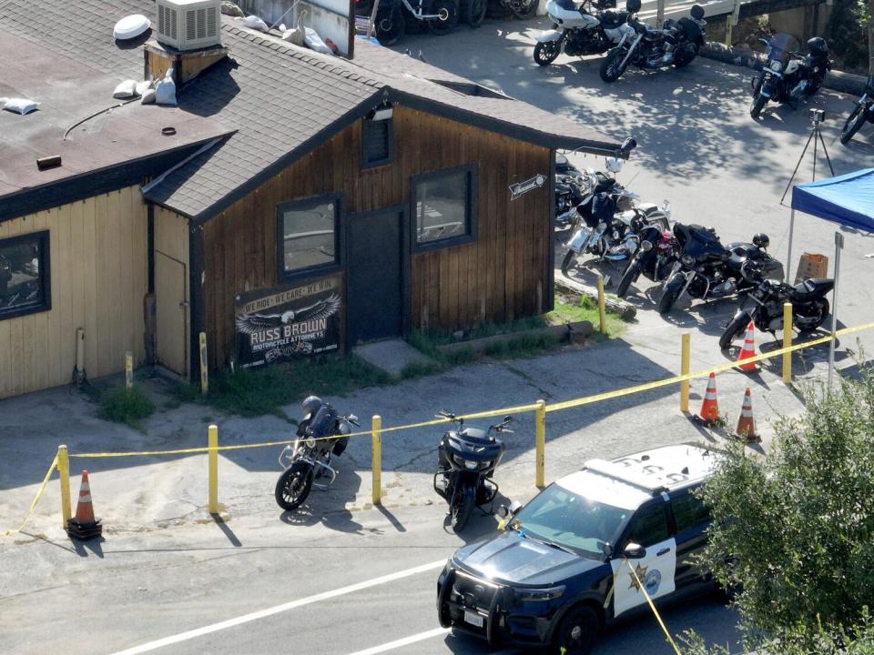 Motorcycles lined up outside Cook's Corner as authorities investigate the shooting.