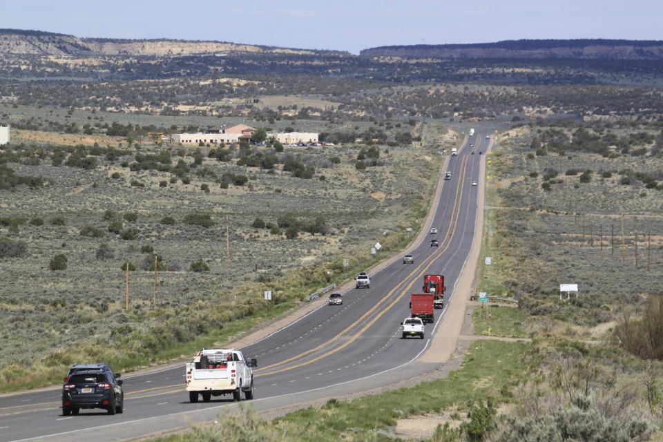 Lybrook Elementary School stands along a main highway near Counselor, N.M., on May 17, 2023. An analysis of state data shows there are 11 active oil wells on state trust land within a mile of the school. On Thursday, June 1, 2023, New Mexico Land Commissioner Stephanie Garcia Richard issued an executive order that includes a ban on all new oil and gas leases on state trust land within a mile (1.6 kilometers) of schools or other educational institutions, including day care centers, preschools and sports facilities that students use. (AP Photo/Susan Montoya Bryan)