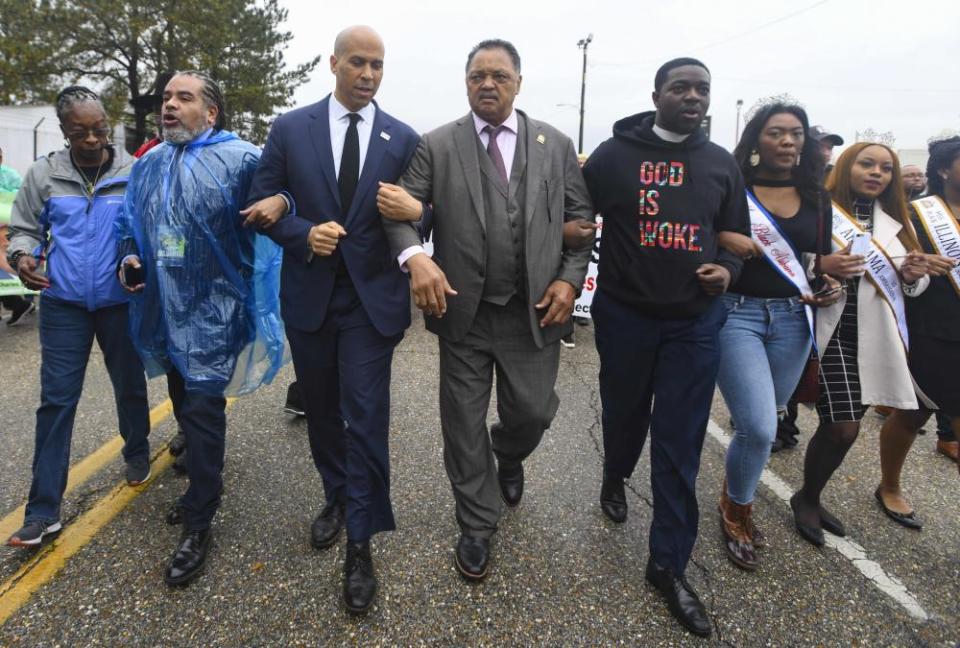 Booker and the Rev Jesse Jackson march to cross the Edmund Pettus Bridge in Selma, Alabama earlier this month.