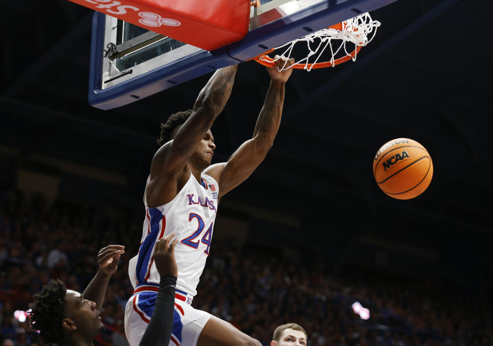 Kansas forward K.J. Adams Jr. (24) scores against Oklahoma State during the first half of an NCAA college basketball game, Tuesday, Jan. 30, 2024, in Lawrence, Kan. (AP Photo/Colin E. Braley)