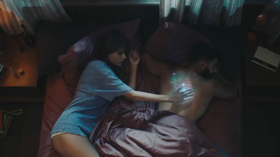 taylor swift and laith ashley lying in bed in the lavender haze music video