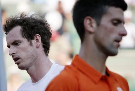 Novak Djokovic of Serbia (R) walks past Andy Murray of Britain during their men's semi-final match at the French Open tennis tournament at the Roland Garros stadium in Paris, France, June 5, 2015. REUTERS/Gonzalo Fuentes